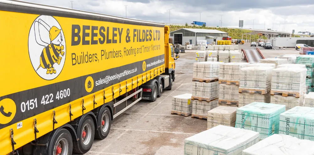 Beesley & Fildes lorry beside pallets of building materials in a merchant's yard