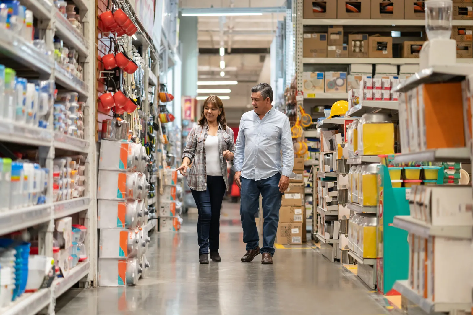 Two shoppers walking down a hardware store aisle