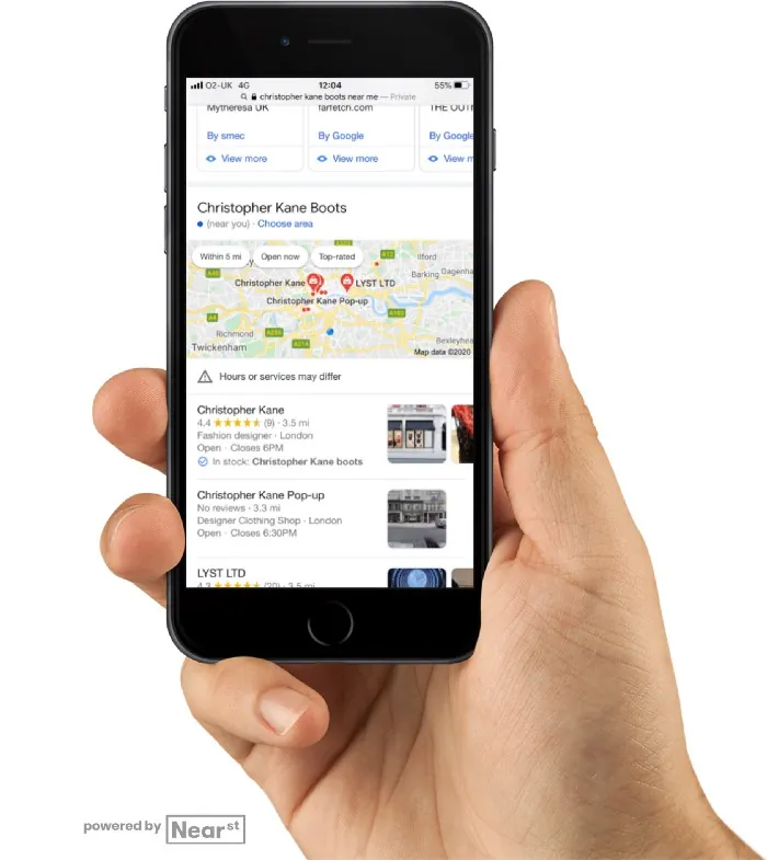 Hand holding a phone showing Google local results for Christopher Kane boots, with a map and nearby shops