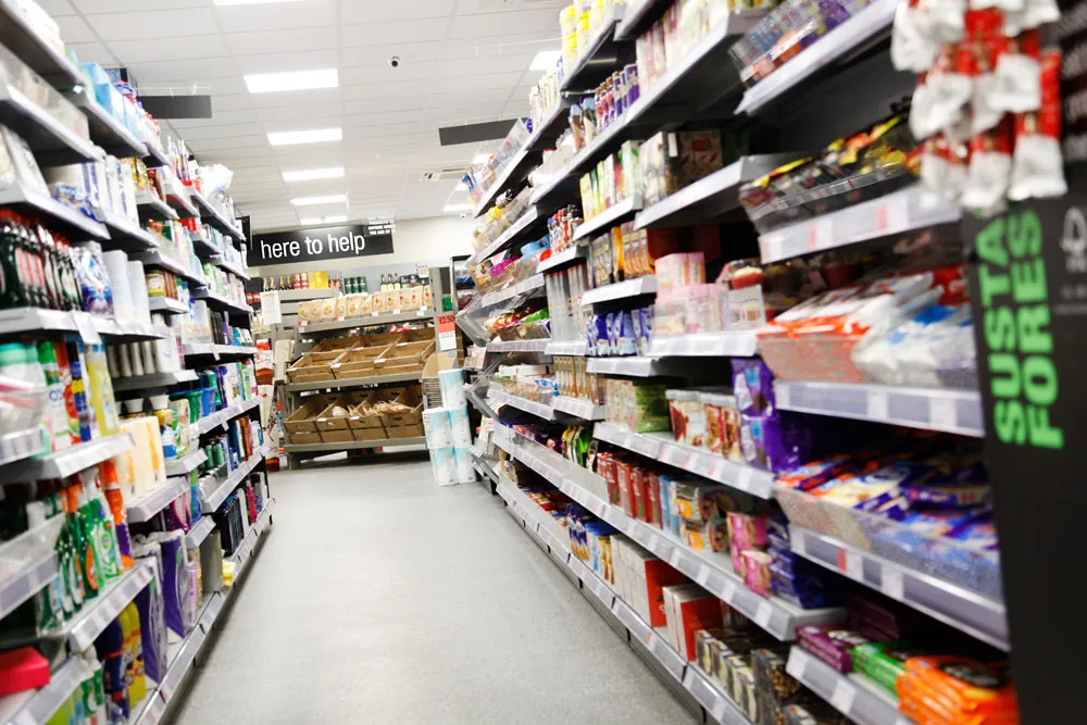 Aisle of a convenience store with fully stocked shelves