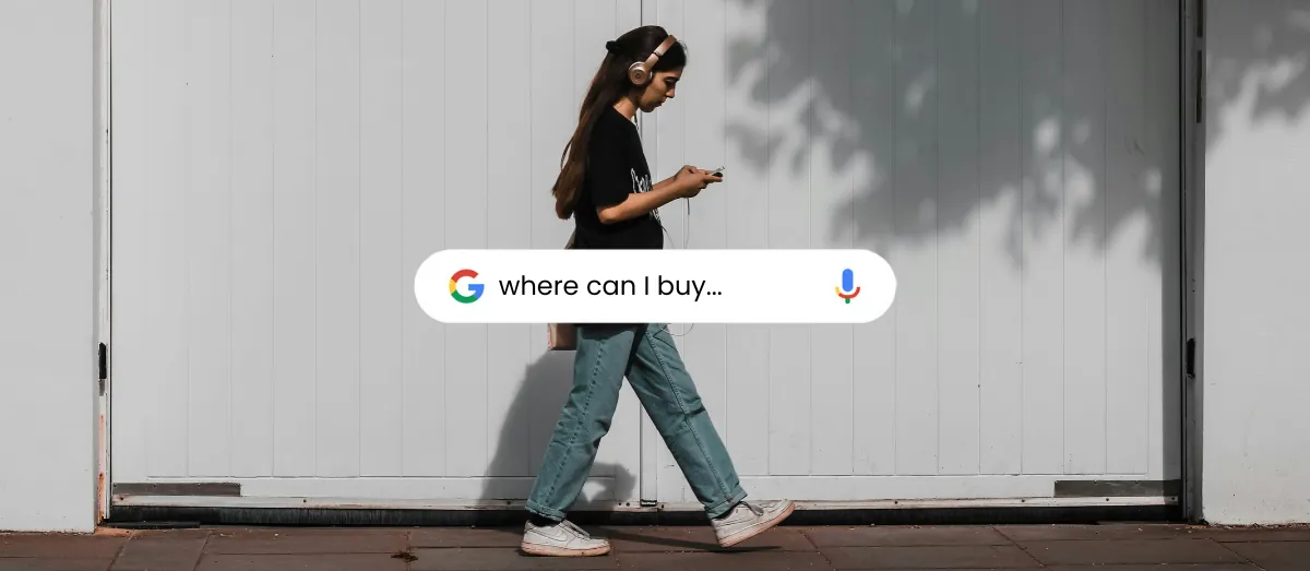 Woman walking while looking at her phone, with a Google search bar reading 'where can I buy...'